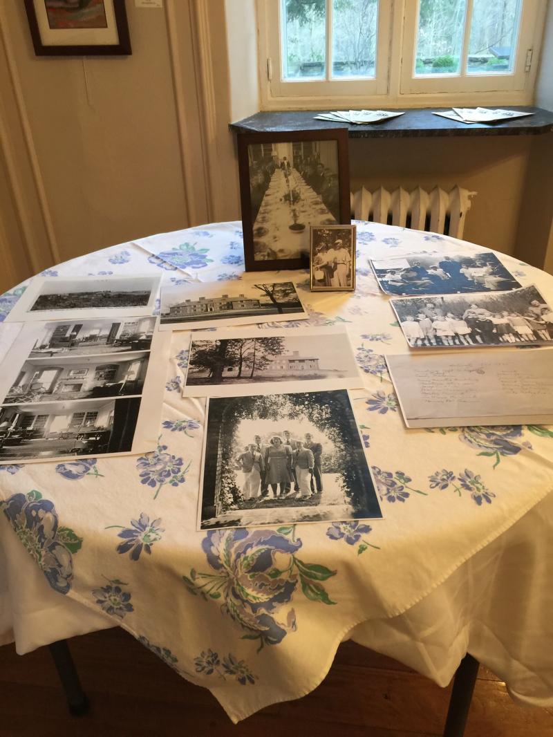 Table1.95124008_std Two tables in the dining room area were set up with many photographs and genealogy charts for visitors to view before and after the formal presentation.